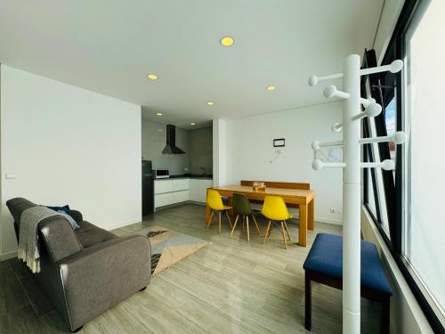 a living room with a couch and a table at Albergue Pilares do Caminho in Marinhas