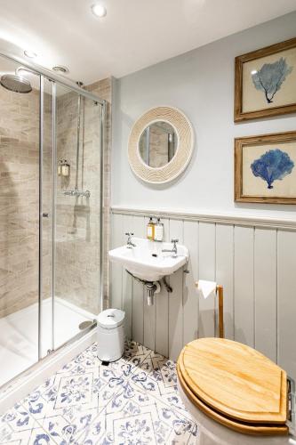 a bathroom with a toilet and a sink and a shower at The Boot Inn in Burton upon Trent
