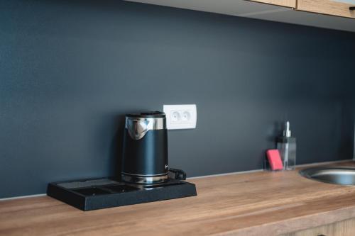 a coffee maker sitting on top of a kitchen counter at ARA Lux Apartments in Utjeha