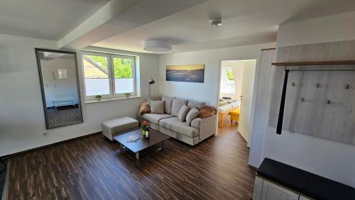a living room with a couch and a table at Ferienwohnung An der Seidewitz in Pirna