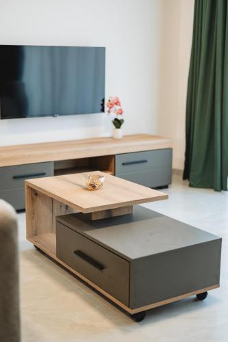 a coffee table in a living room with a tv at ARA Lux Apartments in Utjeha