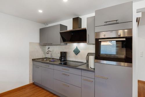 a kitchen with stainless steel cabinets and a sink at Ferienwohnung, 60qm in Frielendorf