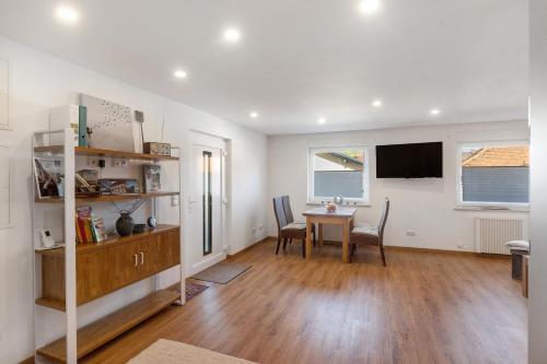 a living room with a table and a tv at Ferienwohnung, 60qm in Frielendorf