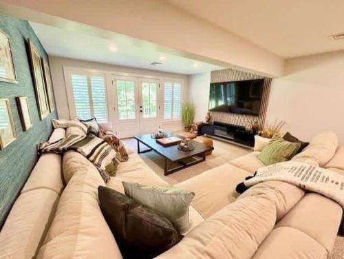 a large living room with a couch and a table at Modern 3b3b Country House and Barn on quiet road in Little Compton