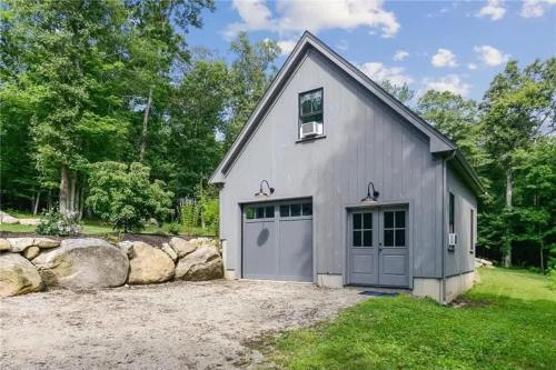 a gray garage with a gray door at Modern 3b3b Country House and Barn on quiet road in Little Compton