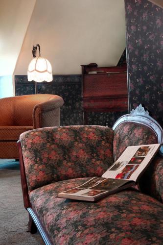 a living room with a couch and a piano at Wilbraham Mansion in Cape May