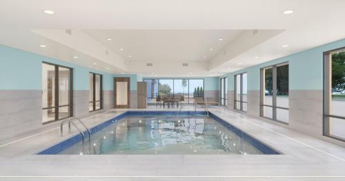 a swimming pool in a house with windows at Holiday Inn Express & Suites Westfield - Indianapolis by IHG in Westfield