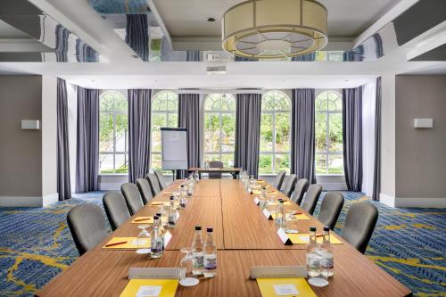 a large conference room with a long table and chairs at Crowne Plaza Gerrards Cross by IHG in Beaconsfield