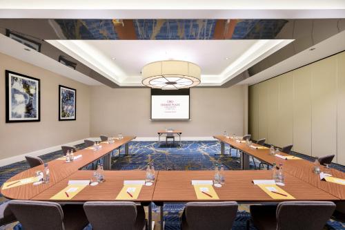 a large conference room with long tables and chairs at Crowne Plaza Gerrards Cross by IHG in Beaconsfield