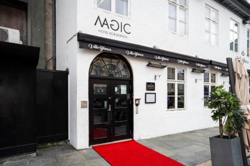a red carpet in front of a building with a door at Magic Hotel Korskirken in Bergen