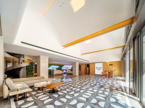 a lobby of a hotel with a couch and chairs at EVEN Hotel Quanzhou City Center by IHG in Quanzhou