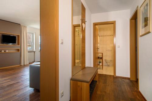 a living room with a bench and a bathroom at Obst- und Ferienhof Lehle in Immenstaad am Bodensee