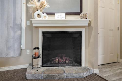 a living room with a fireplace with a mantle at The Perch at Kimberling Crossing in Kimberling City