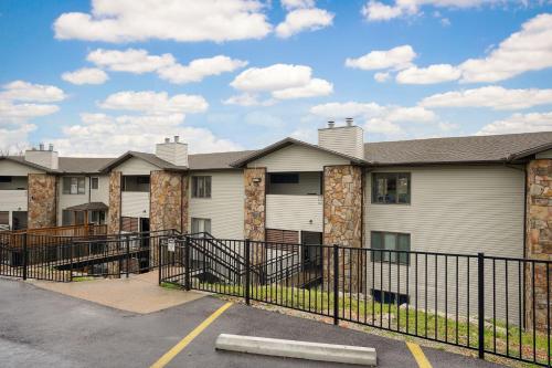 a row of apartment buildings with a black fence at The Perch at Kimberling Crossing in Kimberling City