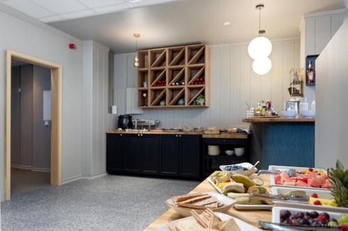 a kitchen with a table with fruits on it at Stracta Hotel Mosfell in Hella