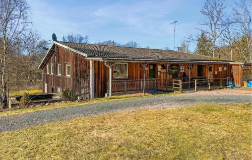 a large wooden house on the side of a road at Nice Apartment In Höör in Höör