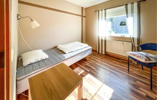 a room with a bed and a table and a window at Nice Apartment In Höör in Höör