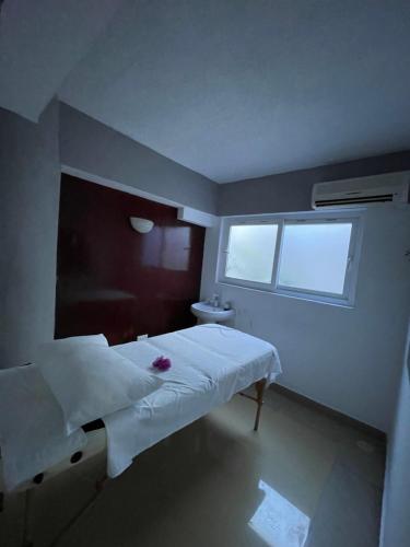 a hospital room with a bed and a window at Sunrise-Nyali, Mombasa in Nyali