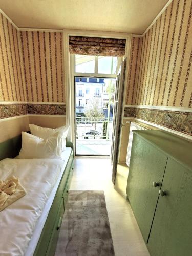a bedroom with a bed and a sliding glass door at Villa Lindenhof in Bad Elster