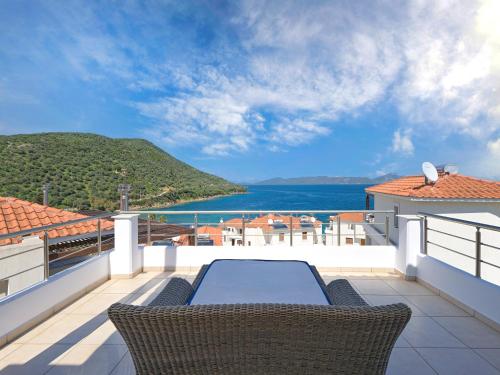 a patio with a table and chairs on a balcony at Olivia Sports and Sea in Pteleós