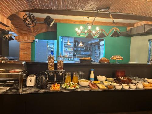 a kitchen with a buffet of food on a counter at Hotel Zerta Old Tbilisi in Tbilisi City