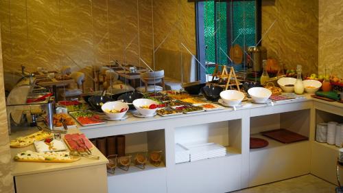 a buffet with many plates of food on a table at SİLVA DELUXE Hotel in Mezitli