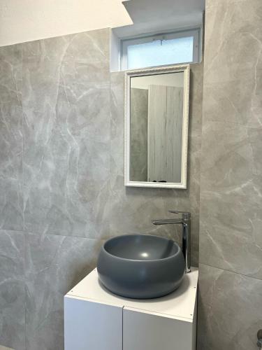 a bathroom with a round sink and a mirror at Venizelos Studios in Plataniás