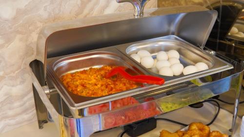 a container of food with eggs and other vegetables at SİLVA DELUXE Hotel in Mezitli