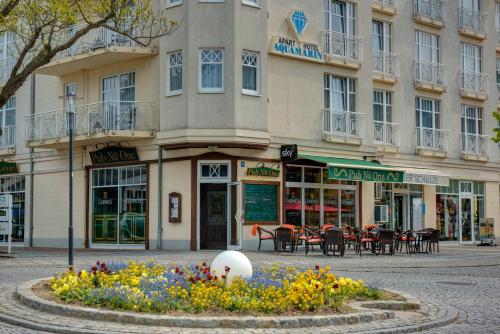 a building with a flower bed in front of it at Hotel Aquamarin in Kühlungsborn