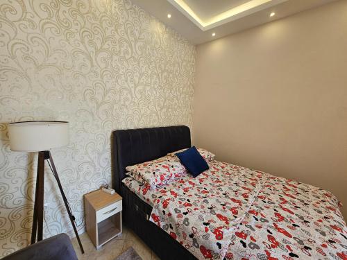 a bedroom with a bed and a lamp in it at Aпартаменты Влаович in Igalo