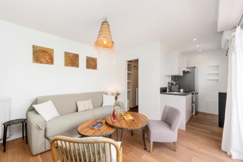 un salon avec un canapé et une table dans l'établissement FLOR DE MAYO - Agréable appartement -Proche Mer - Parking Gratuit, à Roquebrune-Cap-Martin