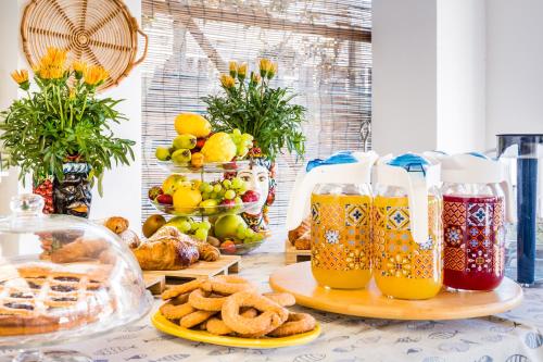 a table with two glasses of juice and food at Villa Giummarito in Scicli