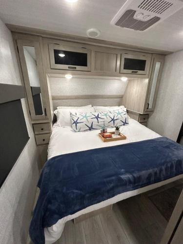a bedroom with a large bed in an rv at The Lake Escape RV Meets The Beach in Foley