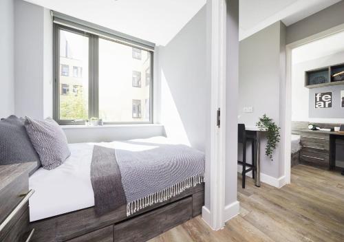 a white bedroom with a bed and a window at For Students Only - Collegiate Crown Place Cardiff in Cardiff