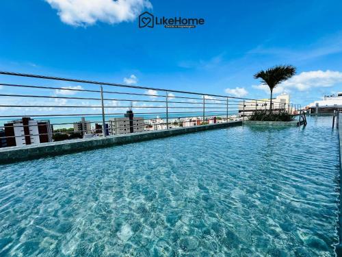 a swimming pool on the roof of a building at Edifício Mindset - LikeHome Hospedagens in João Pessoa