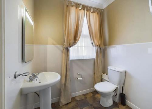 a bathroom with a white toilet and a sink at Edenfield Lodge in Blackpool