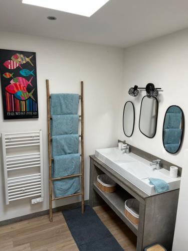 a bathroom with a sink and two mirrors at Maison de vacances ossature bois 2-4 personnes- Saint Gilles Croix de Vie 85800 in Saint-Gilles-Croix-de-Vie