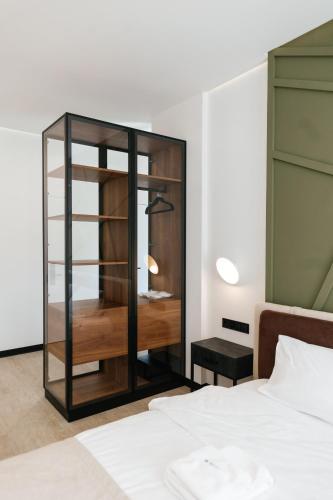 a bedroom with a glass cabinet next to a bed at Select Hotel in Lviv