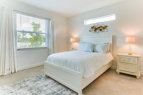 a white bedroom with a bed and a window at 15 Mi to Downtown Fort Myers Golf Getaway in Lehigh Acres