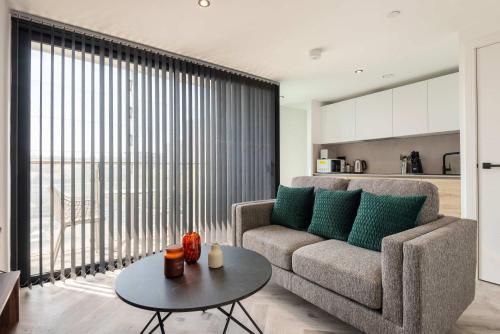 a living room with a couch and a table at Stunning 1 Bedroom Apartment in Central Sheffield in Sheffield