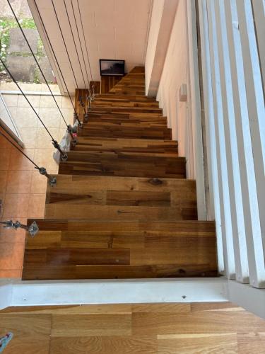 a staircase in a house with wooden floors at Villa Pétrel in Saint-Paul
