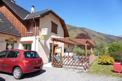 a red car parked in front of a building at Le mas relais du Beaumont in La Salle-en-Beaumont