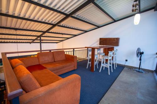 a living room with a couch and a table at Villa Tea Escape in Mahingala
