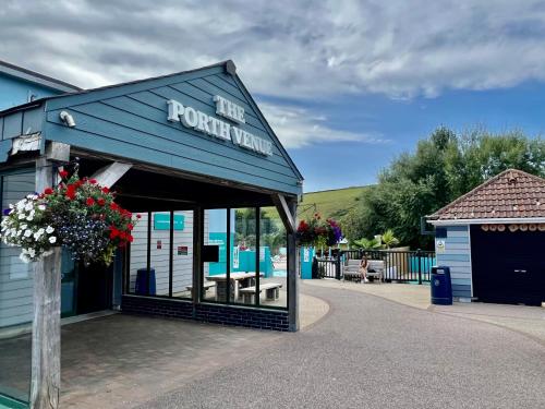 a front view of a building with flowers on it at 3 Bedroom Caravan with Decking at Newquay Bay Resort in Porth