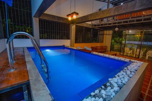 a swimming pool with blue water and a faucet at Villa Tea Escape in Mahingala