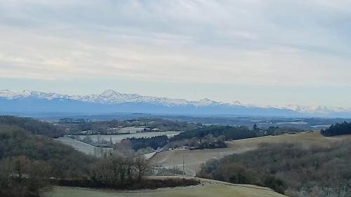 a view of a valley with mountains in the background at Maison chaleureuse à Martisserre avec jardin privatif et cheminée in Martisserre