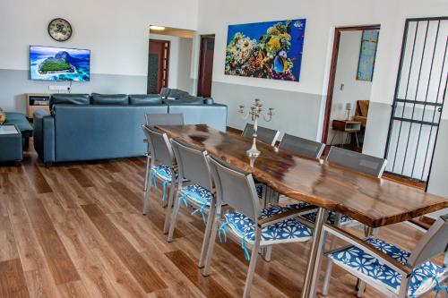 a living room with a wooden table and chairs at Nilaya Penthouse, 3BHK Luxury by Coastal in Roches Noires