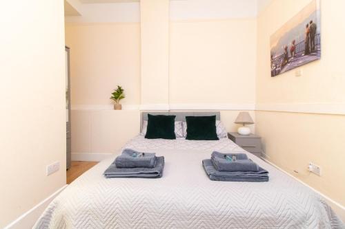 a bedroom with a bed with towels on it at Thornbury Guest House Room 3 in Southampton