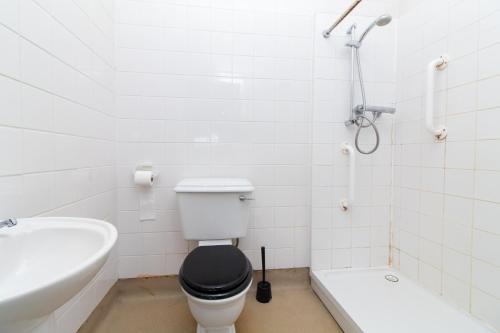 a bathroom with a toilet and a sink and a bath tub at Thornbury Guest House Room 3 in Southampton