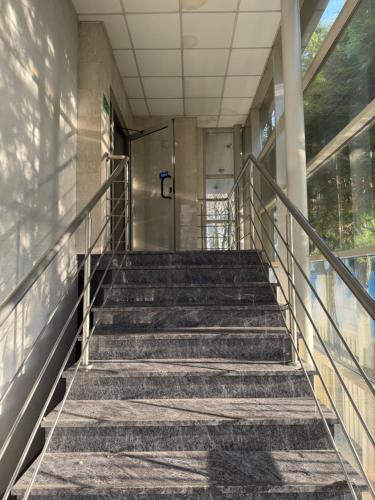 a set of stairs leading up to a door in a building at Hub Property in Góra Kalwaria